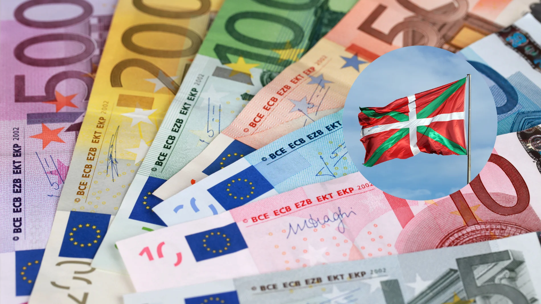 Imagen de varios billetes de dinero junto a la bandera del País Vasco