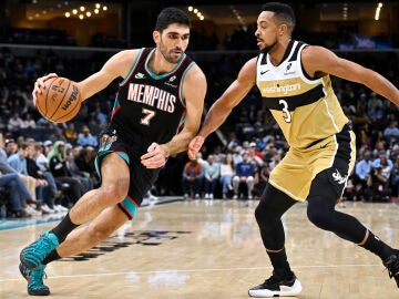 Memphis Grizzlies forward Santi Aldama (7) handles the ball against Washington Wizards guard CJ McCollum (3) in the first half of an NBA basketball game Saturday, Dec. 20, 2025, in Memphis, Tenn. (AP Photo/Brandon Dill)