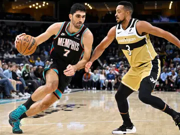 Santi Aldama bota ante la defensa de CJ McCollum Memphis Grizzlies forward Santi Aldama (7) handles the ball against Washington Wizards guard CJ McCollum (3) in the first half of an NBA basketball game Saturday, Dec. 20, 2025, in Memphis, Tenn. (AP Photo/Brandon Dill)