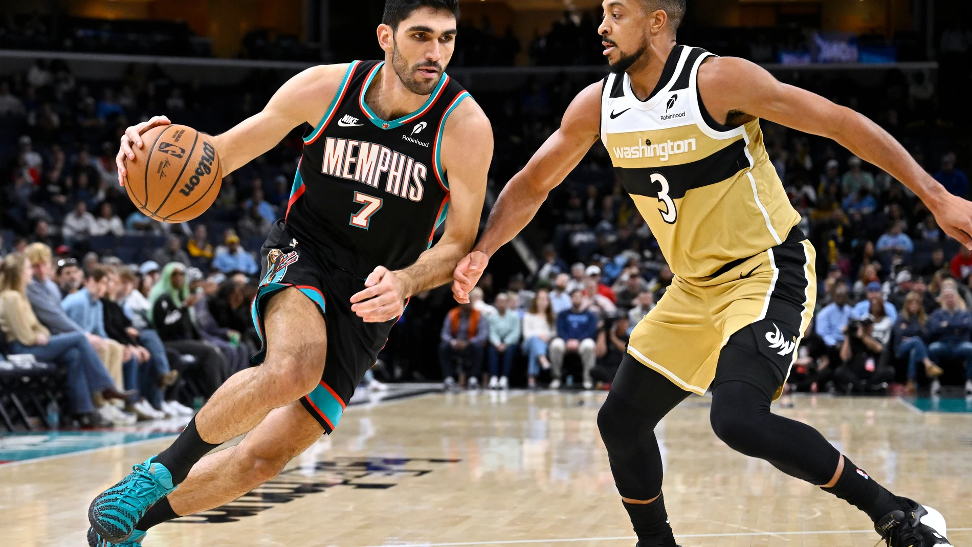Memphis Grizzlies forward Santi Aldama (7) handles the ball against Washington Wizards guard CJ McCollum (3) in the first half of an NBA basketball game Saturday, Dec. 20, 2025, in Memphis, Tenn. (AP Photo/Brandon Dill)