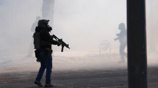 Federal immigration officers deploy tear gas at observers after a shooting Saturday, Jan. 24, 2026, in Minneapolis. (AP Photo/Abbie Parr)