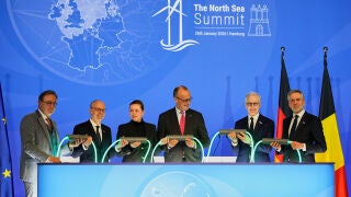 Belgian Prime Minister Bart de Wever, Luxembourg Prime Minister Luc Frieden, Danish Prime Minister Mette Frederiksen, German Chancellor Friedrich Merz, Norway Prime Minister Jonas Gahr, and Dutch Prime Minister Dick Schoof, from left, hold a light connection during the North Sea Summit in Hamburg, Germany, where the North Sea coastal states aim to strengthen cross-border cooperation in the expansion of offshore wind energy and hydrogen infrastructure on Monday, January 26, 2026. (AP Photo/Mar...