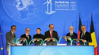Germany North Sea Summit Belgian Prime Minister Bart de Wever, Luxembourg Prime Minister Luc Frieden, Danish Prime Minister Mette Frederiksen, German Chancellor Friedrich Merz, Norway Prime Minister Jonas Gahr, and Dutch Prime Minister Dick Schoof, from left, hold a light connection during the North Sea Summit in Hamburg, Germany, where the North Sea coastal states aim to strengthen cross-border cooperation in the expansion of offshore wind energy and hydrogen infrastructure on Monday, January 26, 2026. (AP Photo/Mar...