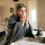 Una mujer tiene un escalofr&iacute;o por la fiebre