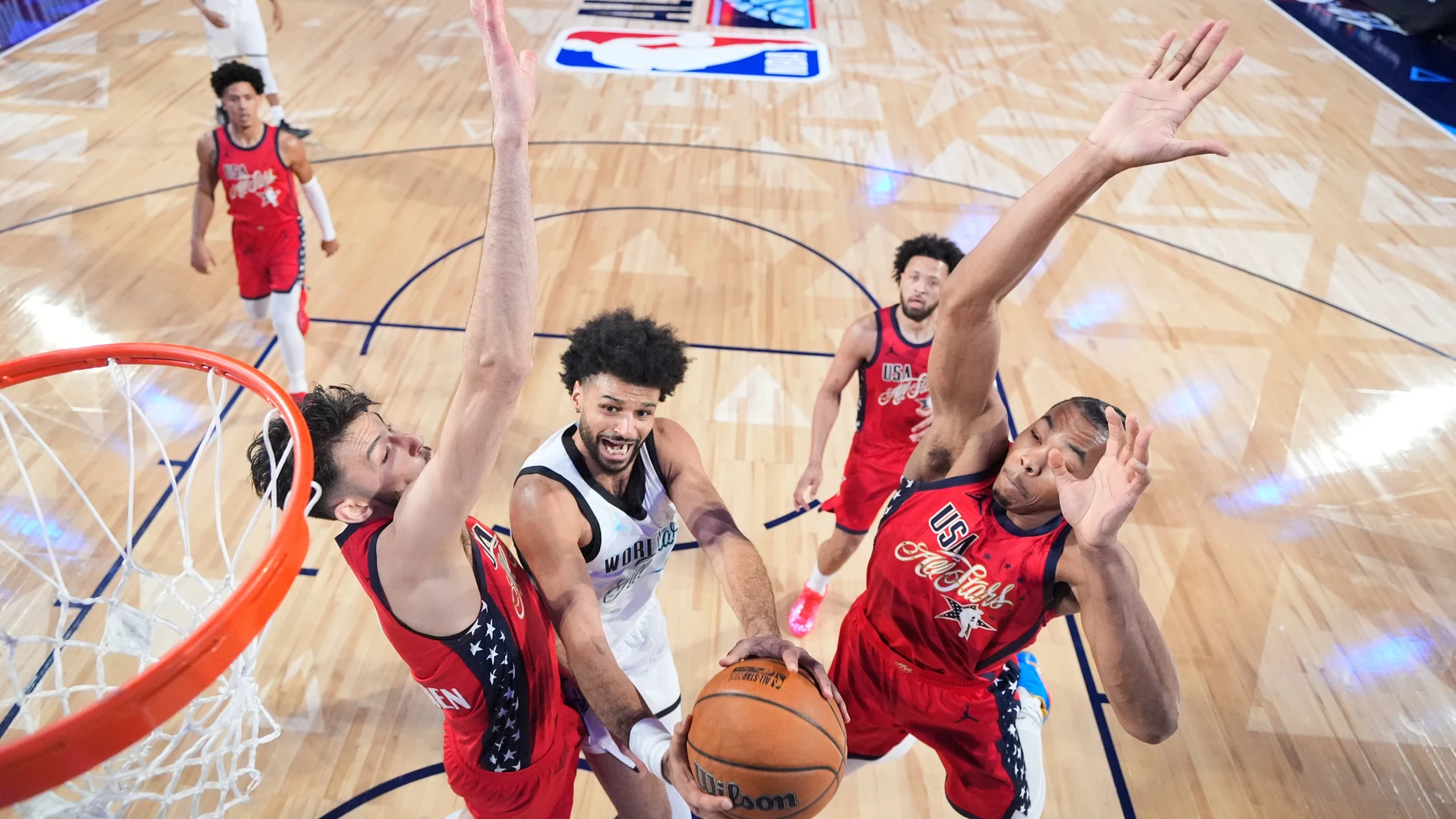 World guard Jamal Murray, of Canada, center drives to the basket against USA Stars in the NBA All-Star basketball game Sunday, Feb. 15, 2026, in Inglewood, Calif. (Ronald Martinez/Pool Photo via AP)