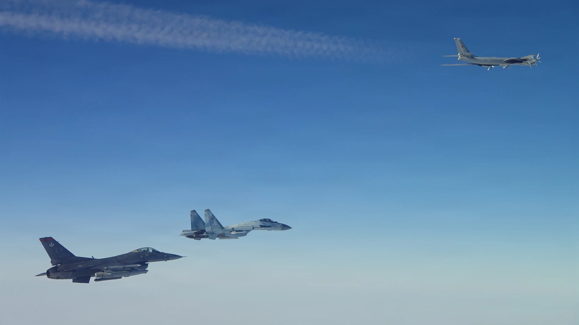 This photo provided by the U.S. Department of Defense shows a North American Aerospace Defense Command F-16 fighter aircraft intercepting Russian Tu-95 and Su-35 military aircraft near the Bering Strait, west of Alaska, on Thursday, Feb. 19, 2026. (Department of Defense photo via AP)
