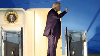 President Donald Trump gestures from Air Force One upon his arrival at Joint Base Andrews, Md., Friday, March 6, 2026.(AP Photo/Luis M. Alvarez)