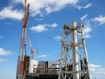 Japan Fukushima FILE - The damaged Unit 1 reactor, back, and the exhaust stack shared by the Unit 1 and 2 reactors are seen at the Fukushima Daiichi nuclear power plant, operated by Tokyo Electric Power Company Holdings (TEPCO), in Okuma town, northeastern Japan, Feb. 20, 2025. (AP Photo/Eugene Hoshiko, File)
