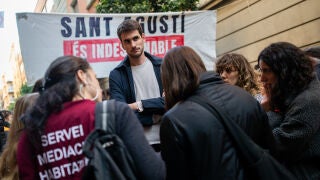 Varias personas hablan con Txema (c), el chico que va a ser desalojado, durante una concentraci&oacute;n para tratar de impedir el desalojo del bloque Sant Agust&iacute;, a 25 de marzo de 2026, en Barcelona, Catalunya (Espa&ntilde;a). El fondo New Amsterdam Developers (NAD) es el propietario del bloque ubicado en el barrio de Gr&agrave;cia sobre el que recae hoy una orden de desalojo. El Ayuntamiento de Barcelona ped&iacute;a ayer a dicho fondo que detuviera el lanzamiento para que se pueda negociar el desalojo con la Sindicat...