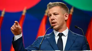 Hungary Election Peter Magyar gestures as he speaks to the media in Budapest, Hungary, Monday, April 13, 2026, after defeating Prime Minister Viktor Orban's party in the country's parliamentary elections. (AP Photo/Denes Erdos)