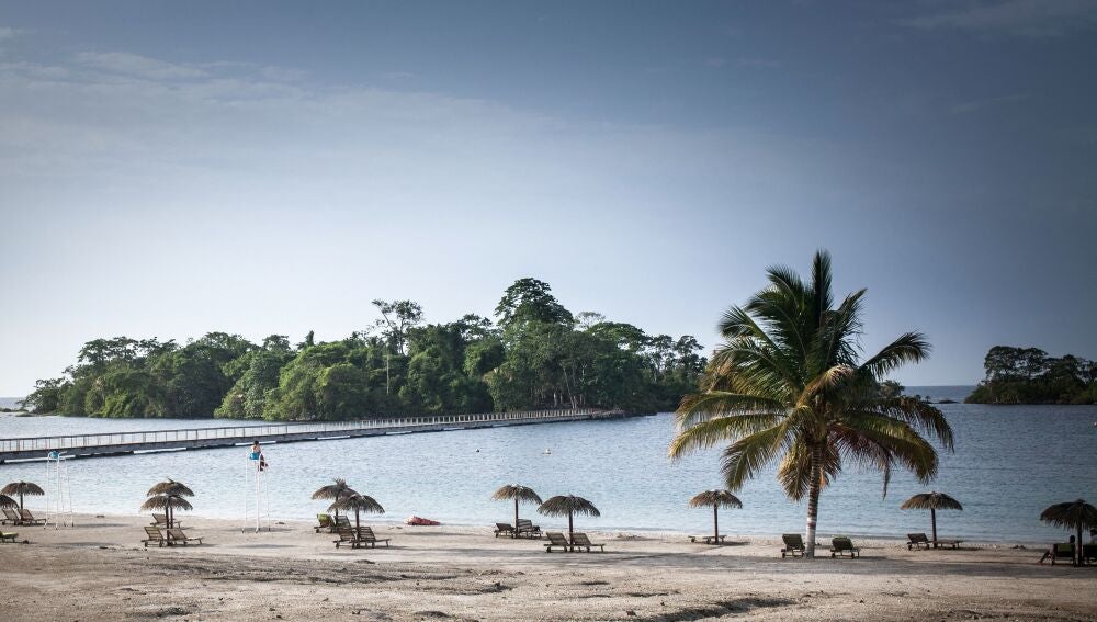 A person sits on a chair on the artificial beach of the Sofitel Hotel, in Sipopo, nearly 16km from Malabo in Equatorial Guinea, on April 20, 2019. In Sipopo, a seaside resort built, on the outskirts of Malabo, to host an African Union summit in 2011, there is an absolute calm. With few cars and even fewer pedestrians, the place struggles to attract businessmen and tourists. (Photo by Camille MALPLAT / AFP)